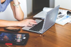 woman writing on a laptop