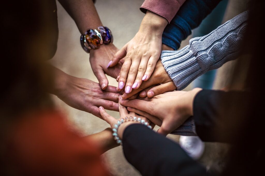 group huddle with hands touching in the center